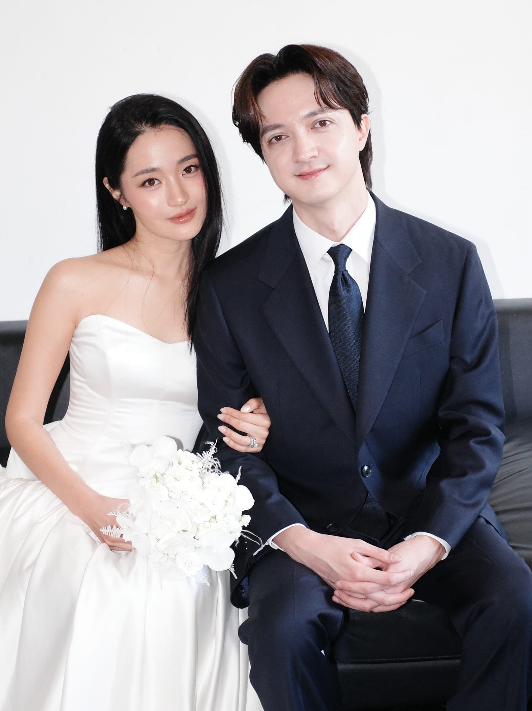 A close portrait of Chaewon and Brandon seated side by side